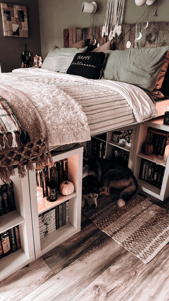 Finished king-size bookshelf bed surrounded by book-filled cube shelving.