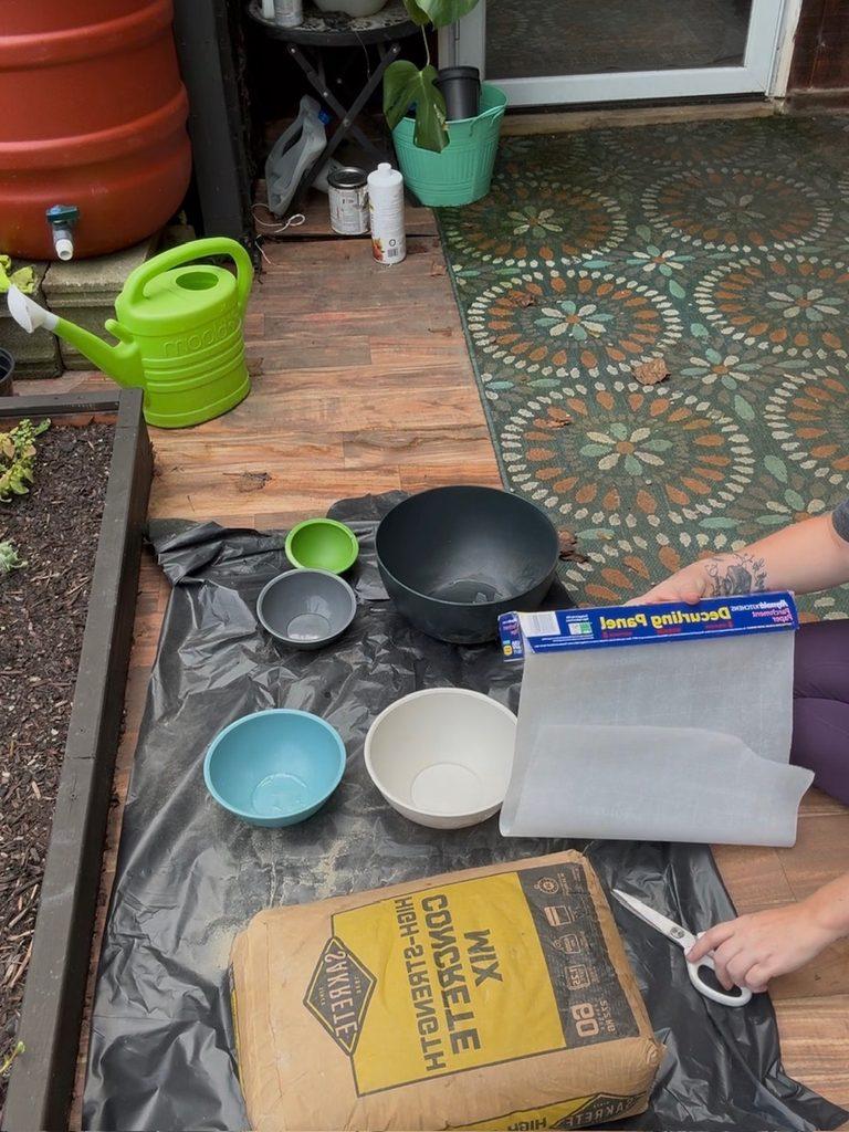 Making DIY concrete mushrooms using bowls as molds